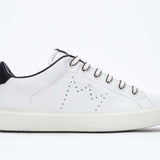 Side profile of low top white sneaker with black detailing and perforated crown logo on upper. Full leather upper and white rubber sole.