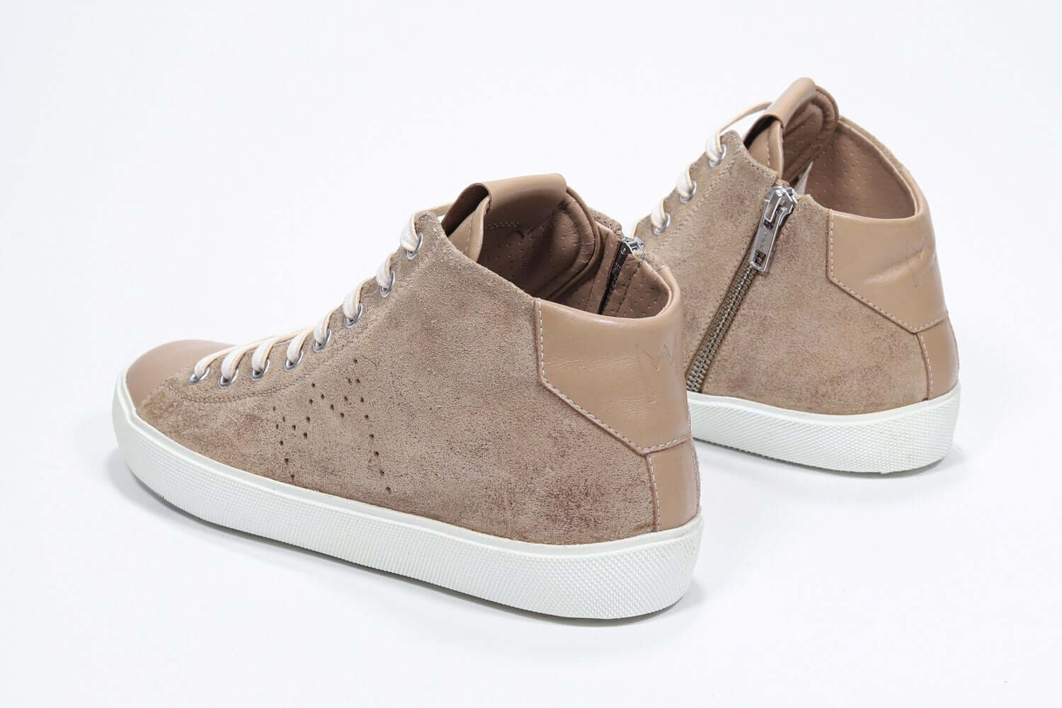 Three quarter back view of mid top cuoio sneaker with full suede upper with perforated crown logo, internal zip and white sole