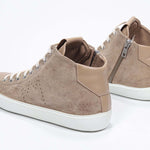 Three quarter back view of mid top cuoio sneaker with full suede upper with perforated crown logo, internal zip and white sole