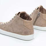 Three quarter back view of mid top cuoio sneaker with full suede upper with perforated crown logo, internal zip and white sole
