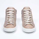 Front view of mid top cuoio sneaker with full suede upper with perforated crown logo, internal zip and white sole