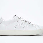 Side profile of low top white sneaker with perforated crown logo on upper. Full leather upper and white rubber sole.