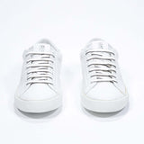 Front view of low top white sneaker with perforated crown logo on upper. Full leather upper and white rubber sole.