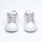 Front view of low top white sneaker with black detailing and perforated crown logo on upper. Full leather upper and white rubber sole.