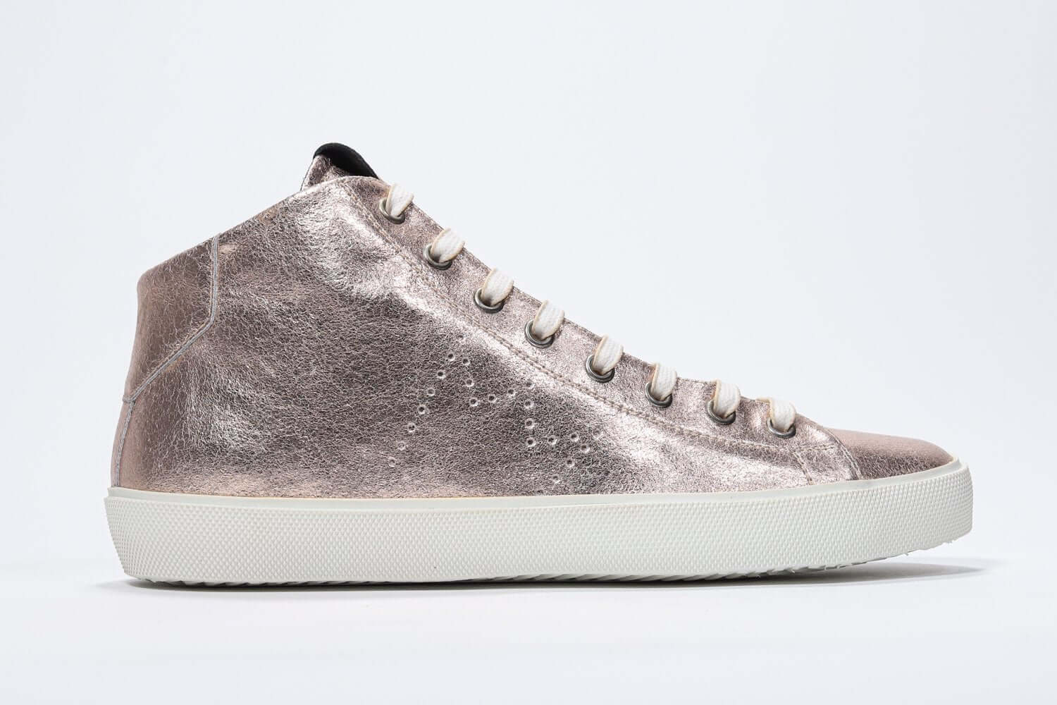 Side profile of mid top rose-gold sneaker with full leather upper with perforated crown logo, internal zip and white sole.