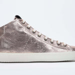 Side profile of mid top rose-gold sneaker with full leather upper with perforated crown logo, internal zip and white sole.