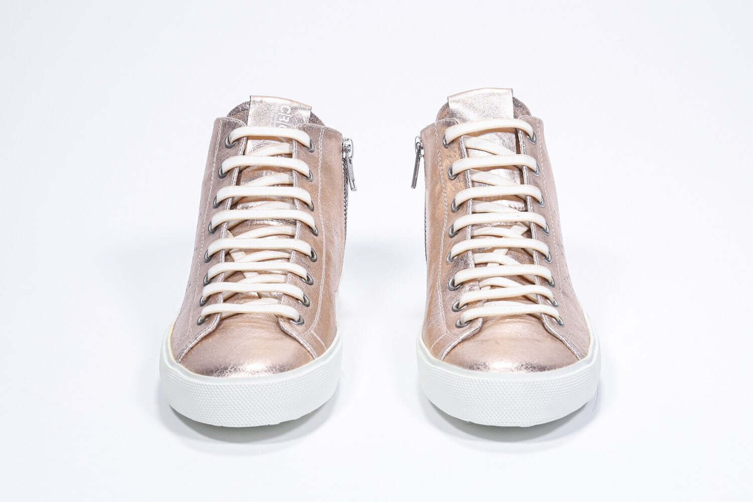 Front view of mid top rose-gold sneaker with full leather upper with perforated crown logo, internal zip and white sole.