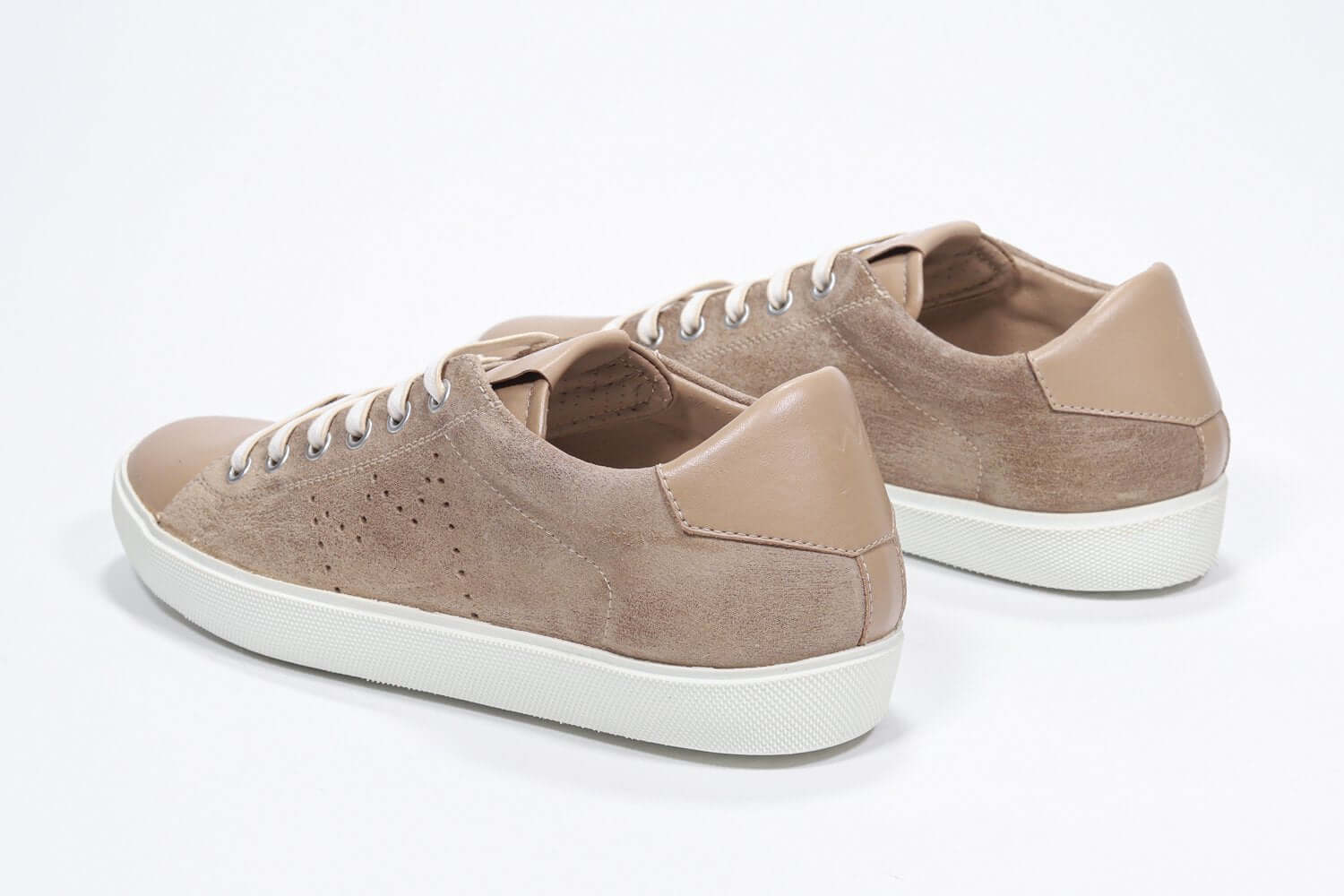 Three quarter back view of low top cuoio sneaker with perforated crown logo on upper. Full suede upper and white rubber sole.