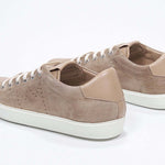 Three quarter back view of low top cuoio sneaker with perforated crown logo on upper. Full suede upper and white rubber sole.