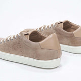 Three quarter back view of low top cuoio sneaker with perforated crown logo on upper. Full suede upper and white rubber sole.
