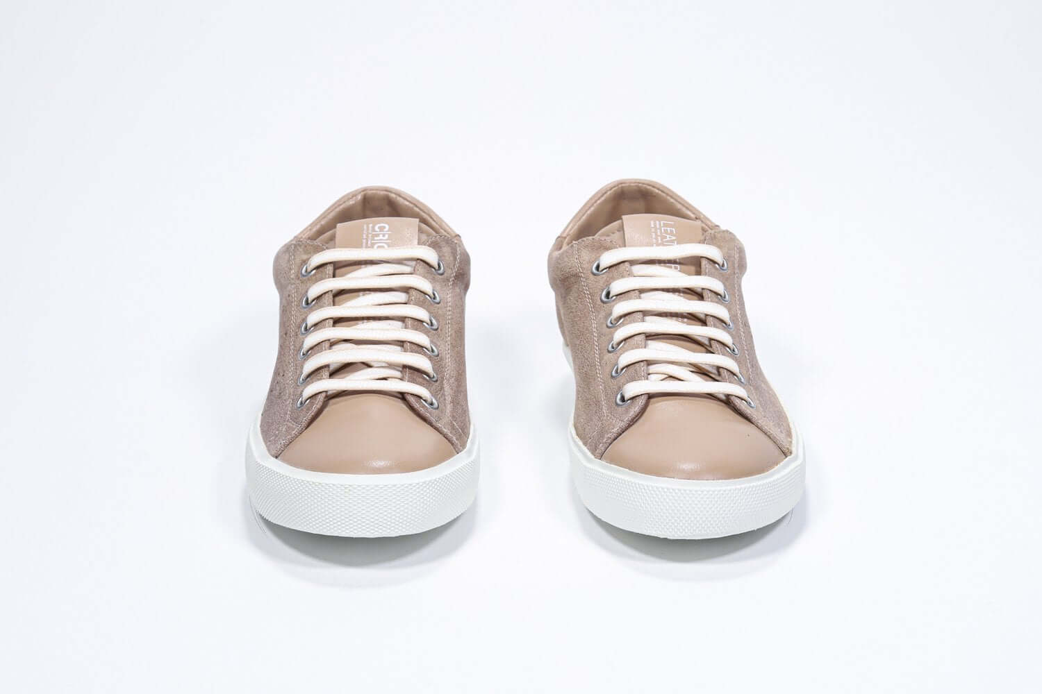 Front view of low top cuoio sneaker with perforated crown logo on upper. Full suede upper and white rubber sole.